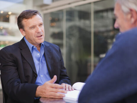 Two men discussing a business deal