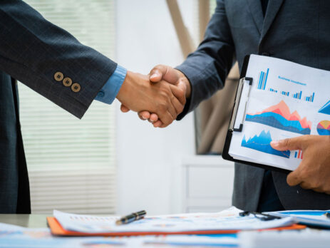 A business acquirer shaking hands with business owner