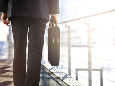 man walking away with his brief case after the sale of his business