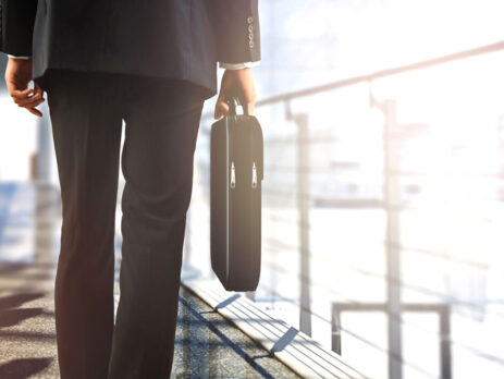 man walking away with his brief case after the sale of his business