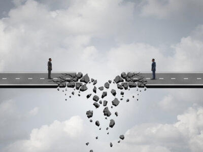 the road crumbling apart in front of two business men who are trying to close a deal