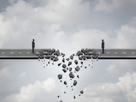 the road crumbling apart in front of two business men who are trying to close a deal