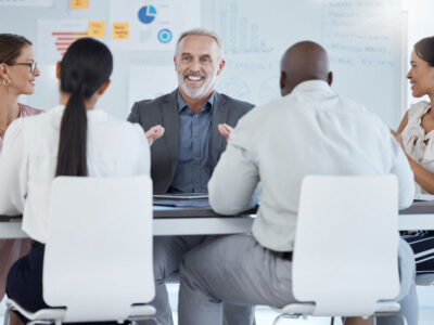 Business owner telling his employees that he is selling his business